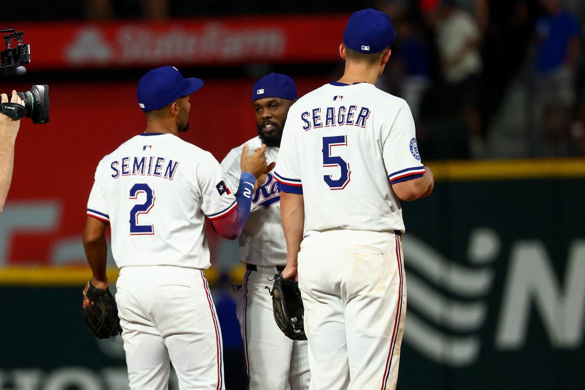 Jul 22, 2025; Arlington, Texas, USA; Texas Rangers shortstop Corey Seager (5) celebrates with Texas Rangers second baseman Marcus Semien (2) and Texas Rangers right fielder Adolis Garcia (53) after the game against the Athletics at Globe Life Field. Mandatory Credit: Kevin Jairaj-Imagn Images