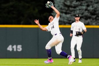 Jul 22, 2025; Denver, Colorado, USA; Colorado Rockies shortstop Ezequiel Tovar (14) fields the ball in the fifth inning against the St. Louis Cardinals at Coors Field. Mandatory Credit: Ron Chenoy-Imagn Images