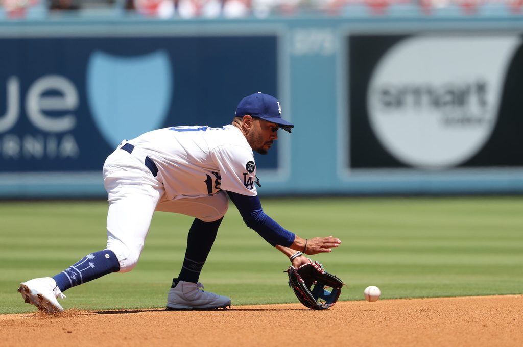 Jul 23, 2025; Los Angeles, California, USA; Los Angeles Dodgers shortstop Mookie Betts (50) fields a ground ball during the second inning against the Minnesota Twins at Dodger Stadium. Mandatory Credit: Kiyoshi Mio-Imagn Images