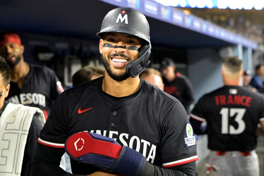 Jul 22, 2025; Los Angeles, California, USA; Minnesota Twins shortstop Carlos Correa (4) in the dugout after scoring a run against the Los Angeles Dodgers at Dodger Stadium. Mandatory Credit: Jayne Kamin-Oncea-Imagn Images