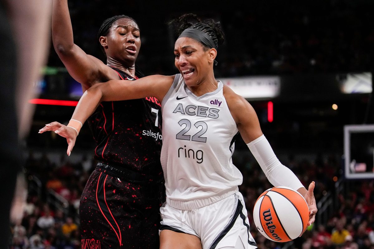 Las Vegas Aces center A'ja Wilson (22) rushes up the court against Indiana Fever forward Aliyah Boston (7) on Thursday, July 24, 2025, during the game at Gainbridge Fieldhouse in Indianapolis.