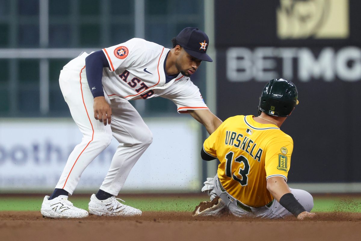 Jul 24, 2025; Houston, Texas, USA; Athletics third baseman Gio Urshela (13) is out on a stolen base attempt as Houston Astros second baseman Brice Matthews (28) applies a tag during the eighth inning at Daikin Park. Mandatory Credit: Troy Taormina-Imagn Images