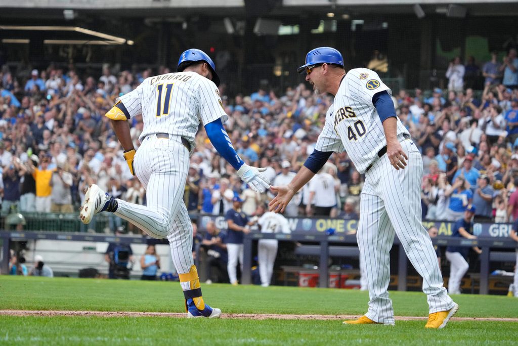 Jul 25, 2025; Milwaukee, Wisconsin, USA; Milwaukee Brewers outfielder Jackson Chourio (11) is congratulated by third base coach Jason Lane (40) while rounding the bases after hitting a home run against the Miami Marlins in the fourth at American Family Field. Mandatory Credit: Michael McLoone-Imagn Images
