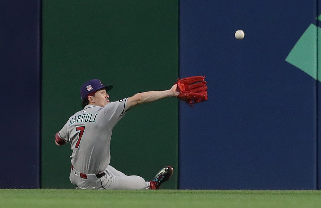 Jul 26, 2025; Pittsburgh, Pennsylvania, USA;  Arizona Diamondbacks center fielder Corbin Carroll (7) makes a catch for an out against Pittsburgh Pirates third baseman Ke'Bryan Hayes (not pictured) during the fourth inning at PNC Park. Mandatory Credit: Charles LeClaire-Imagn Images