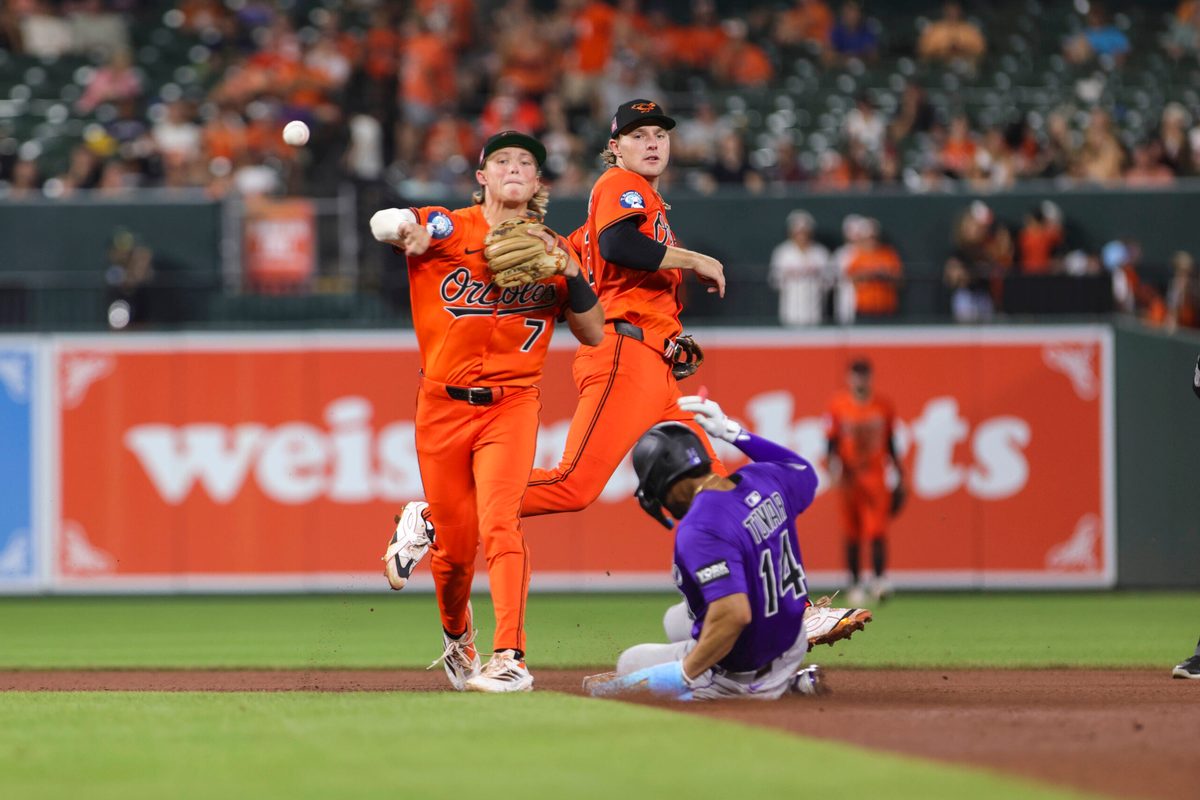 Jul 26, 2025; Baltimore, Maryland, USA; Baltimore Orioles’ second Baseman Jackson Holliday (7) turns a double play against the Colorado Rockies in the seventh inning at Oriole Park at Camden Yards. Mandatory Credit: Lexi Thompson-Imagn Images