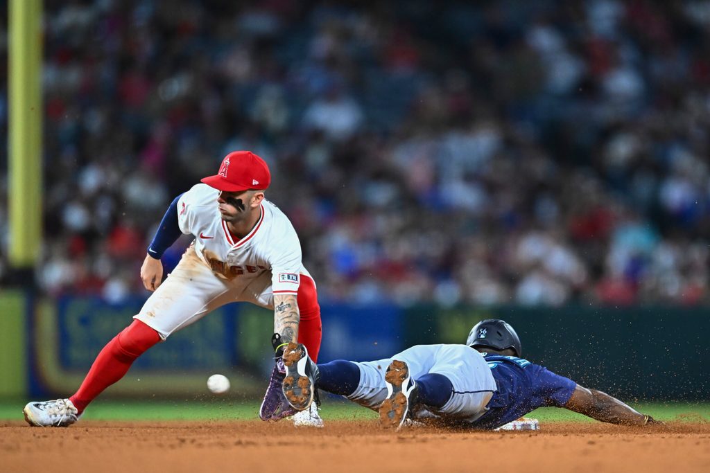 Jul 26, 2025; Anaheim, California, USA; Seattle Mariners outfielder Randy Arozarena (56) steals second base against Los Angeles Angels shortstop Zach Neto (9) during the sixth inning at Angel Stadium. Mandatory Credit: Jonathan Hui-Imagn Images