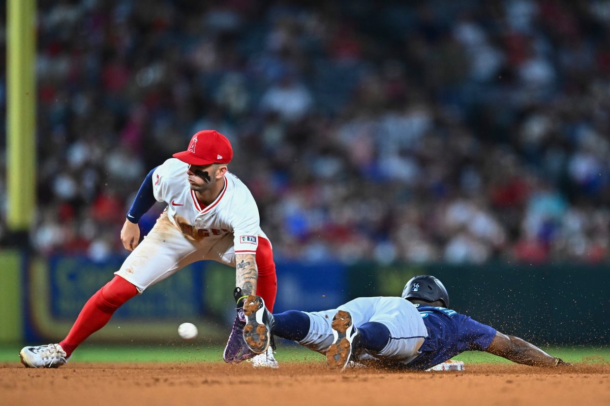 Jul 26, 2025; Anaheim, California, USA; Seattle Mariners outfielder Randy Arozarena (56) steals second base against Los Angeles Angels shortstop Zach Neto (9) during the sixth inning at Angel Stadium. Mandatory Credit: Jonathan Hui-Imagn Images