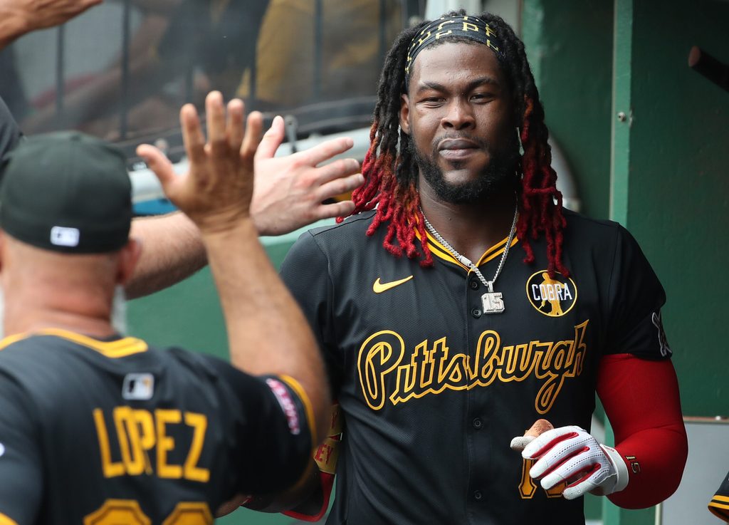 Jul 27, 2025; Pittsburgh, Pennsylvania, USA;  Pittsburgh Pirates center fielder Oneil Cruz (15) celebrates in the dugout after scoring a run against the Arizona Diamondbacks during the second inning at PNC Park. Mandatory Credit: Charles LeClaire-Imagn Images