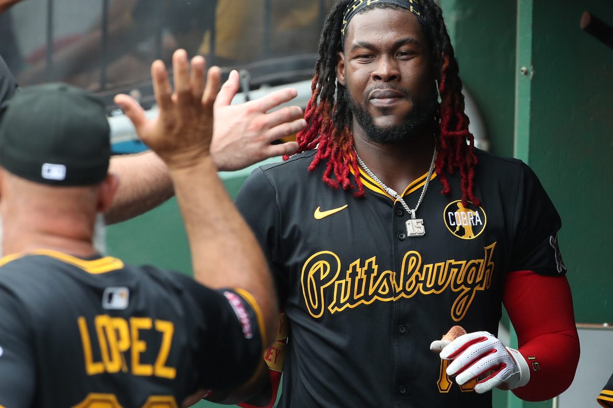 Jul 27, 2025; Pittsburgh, Pennsylvania, USA; Pittsburgh Pirates center fielder Oneil Cruz (15) celebrates in the dugout after scoring a run against the Arizona Diamondbacks during the second inning at PNC Park. Mandatory Credit: Charles LeClaire-Imagn Images
