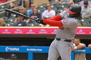 Jul 27, 2025; Minneapolis, Minnesota, USA;  Washington Nationals designated hitter Josh Bell (19) hits a single against the Minnesota Twins during the seventh inning at Target Field. Mandatory Credit: Nick Wosika-Imagn Images