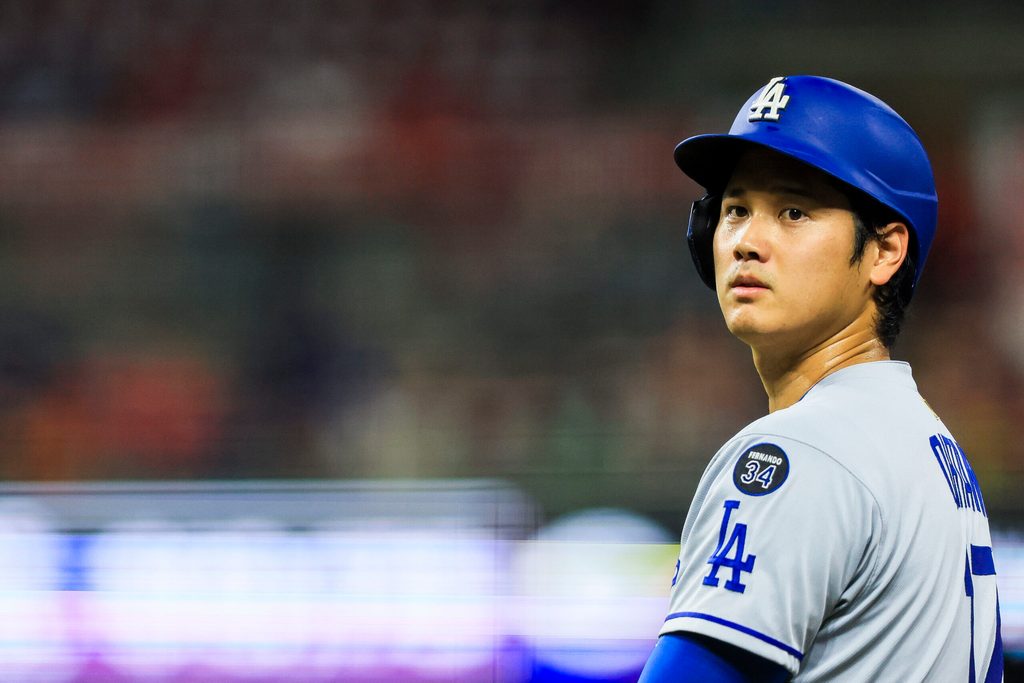 Jul 28, 2025; Cincinnati, Ohio, USA; Los Angeles Dodgers designated hitter Shohei Ohtani (17) stands on first base during a stop in play in the eighth inning against the Cincinnati Reds at Great American Ball Park. Mandatory Credit: Katie Stratman-Imagn Images