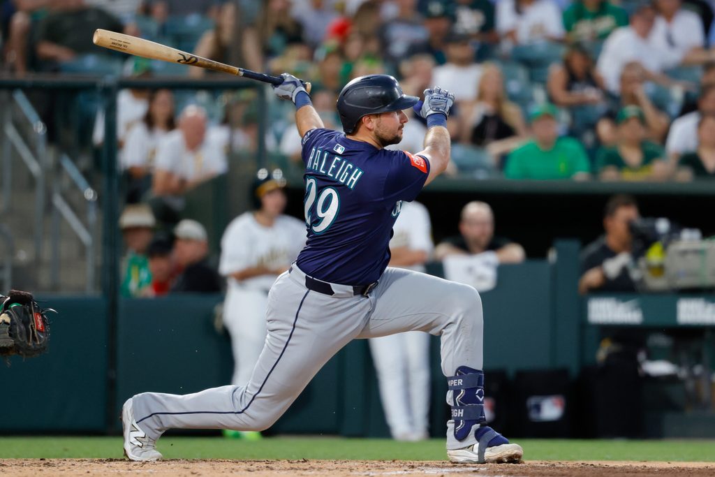 Jul 28, 2025; West Sacramento, California, USA; Seattle Mariners catcher Cal Raleigh (29) hits an RBI single during the fifth inning against the Athletics at Sutter Health Park. Mandatory Credit: Sergio Estrada-Imagn Images
