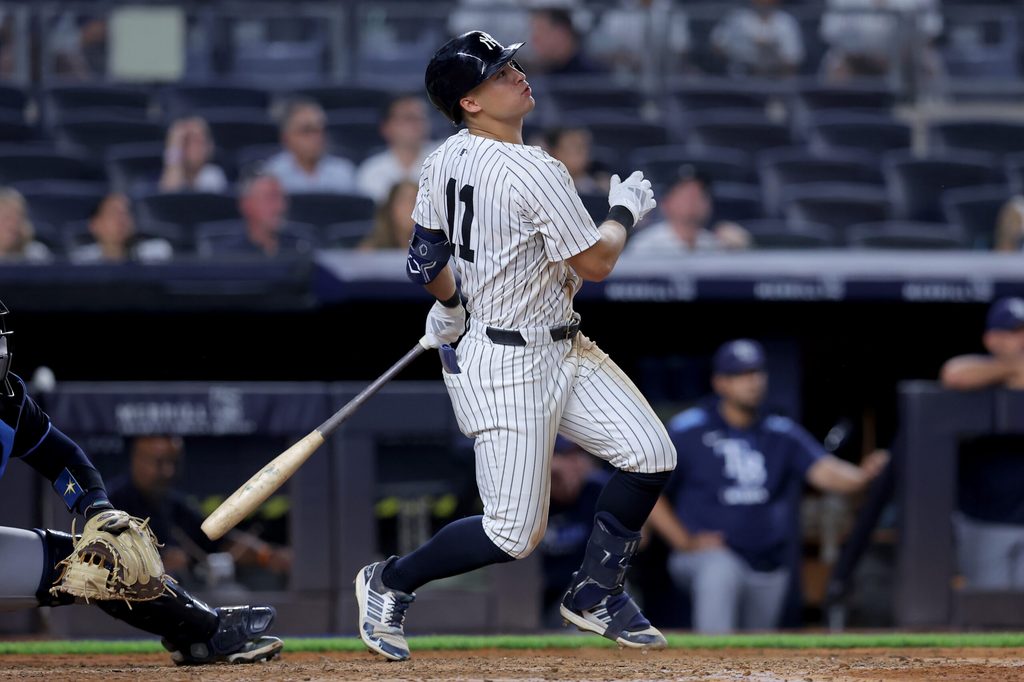 Jul 29, 2025; Bronx, New York, USA; New York Yankees shortstop Anthony Volpe (11) follows through on a solo home run against the Tampa Bay Rays during the eighth inning at Yankee Stadium. Mandatory Credit: Brad Penner-Imagn Images