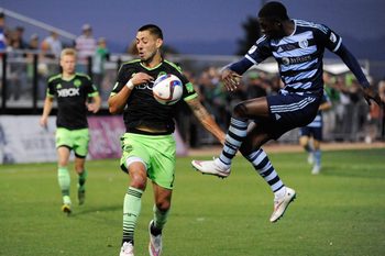 Feb 28, 2015; Tucson, AZ, USA; Sporting Kansas City defender Jalil Anibaba (right) battles for the ball with Seattle Sounders FC forward Clint Dempsey (2) during the second half at Kino North Stadium. Mandatory Credit: Casey Sapio-Imagn Images