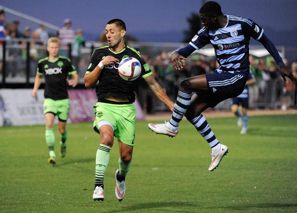Feb 28, 2015; Tucson, AZ, USA; Sporting Kansas City defender Jalil Anibaba (right) battles for the ball with Seattle Sounders FC forward Clint Dempsey (2) during the second half at Kino North Stadium. Mandatory Credit: Casey Sapio-Imagn Images