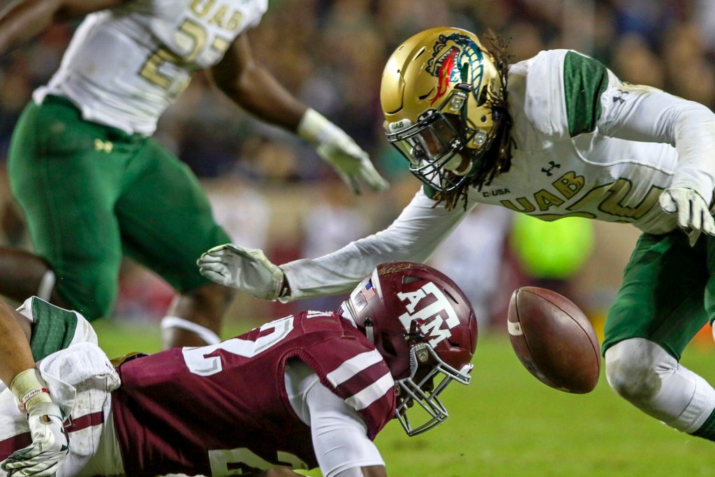 Nov 17, 2018; College Station, TX, USA; Texas A&M Aggies running back Kwame Etwi (22) fumbles the ball during the fourth quarter against the UAB Blazers at Kyle Field. Mandatory Credit: John Glaser-Imagn Images