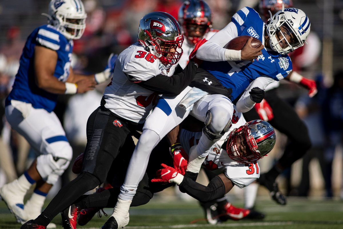 Dec 26, 2020; Mobile, AL, USA; Western Kentucky Hilltoppers linebacker Kyle Bailey (36) and defensive back Antwon Kincade (31) hit Georgia State Panthers quarterback Cornelious Brown IV (4) during the first quarter at Ladd-Peebles Stadium. Mandatory Credit: Vasha Hunt-Imagn Images