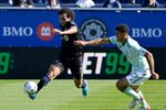 Apr 30, 2022; Montreal, Quebec, CAN; CF Montreal midfielder Ahmed Hamdi (7) plays the ball and Atlanta United FC defender Miles Robinson (12) defends during the first half at Stade Saputo. Mandatory Credit: Eric Bolte-Imagn Images