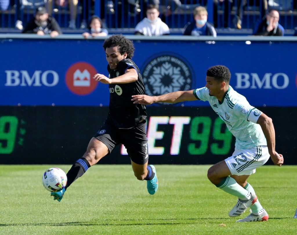 Apr 30, 2022; Montreal, Quebec, CAN; CF Montreal midfielder Ahmed Hamdi (7) plays the ball and Atlanta United FC defender Miles Robinson (12) defends during the first half at Stade Saputo. Mandatory Credit: Eric Bolte-Imagn Images