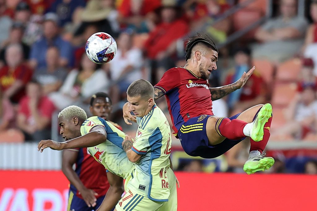 Jul 15, 2023; Sandy, Utah, USA; Real Salt Lake forward Chicho Arango jumper for a header against New York Red Bulls defender John Tolkin (47) and defender Andres Reyes (4) in the second half at America First Field. Mandatory Credit: Rob Gray-Imagn Images