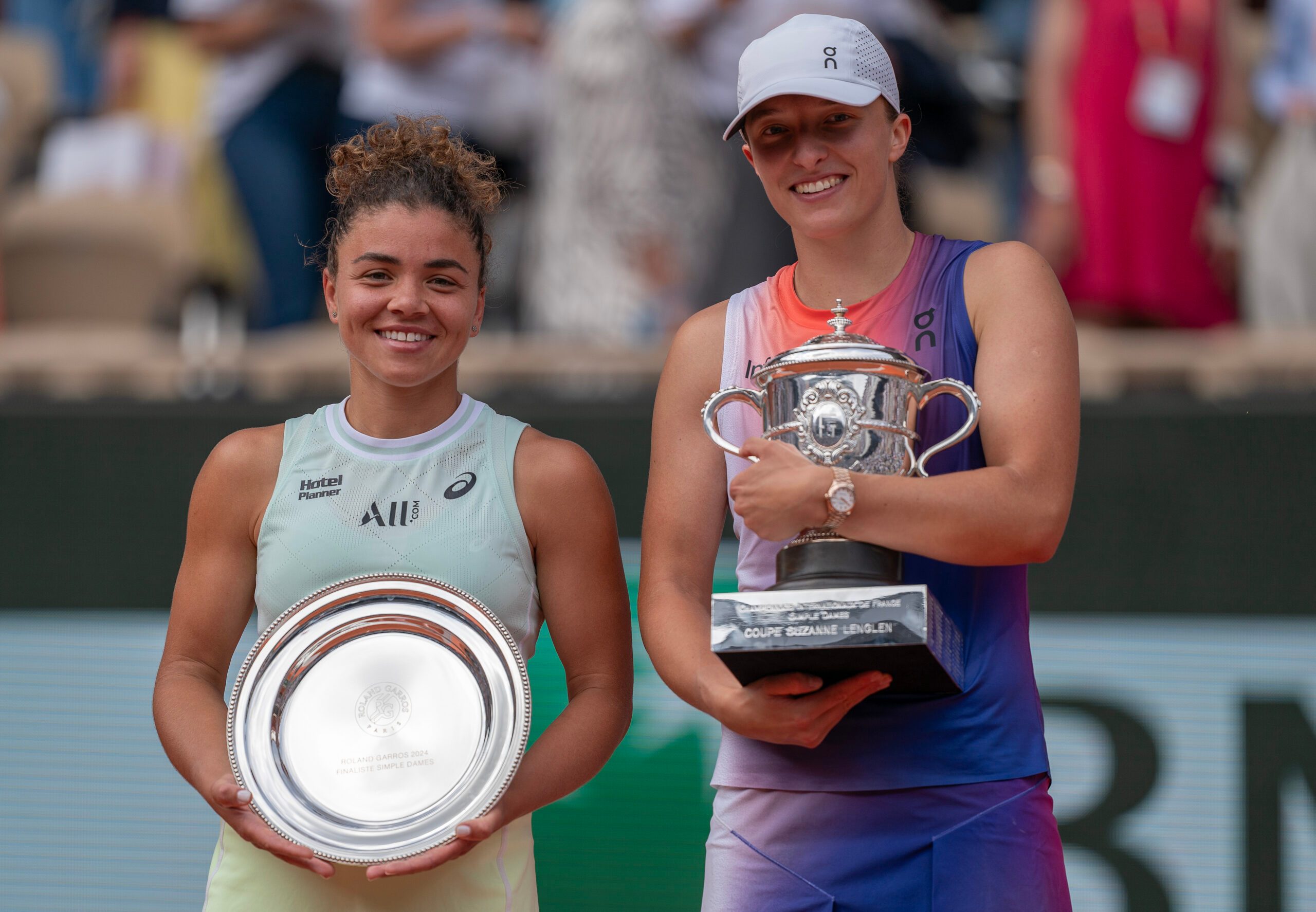 Jun 8, 2024; Paris, France; Iga Swiatek of Poland and Jasmine Paolini of Italy pose with their trophies after the womenís final on day 14 of Roland Garros at Stade Roland Garros. Mandatory Credit: Susan Mullane-Imagn Images