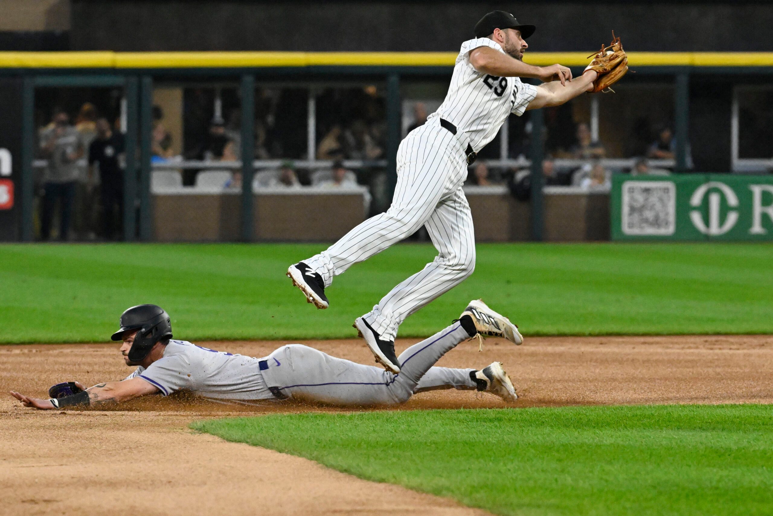 Jun 27, 2024; Chicago, Illinois, USA; Colorado Rockies outfielder Brenton Doyle (9) steals second base under Chicago White Sox shortstop Paul DeJong (29) during the first inning at Guaranteed Rate Field. Mandatory Credit: Matt Marton-Imagn Images