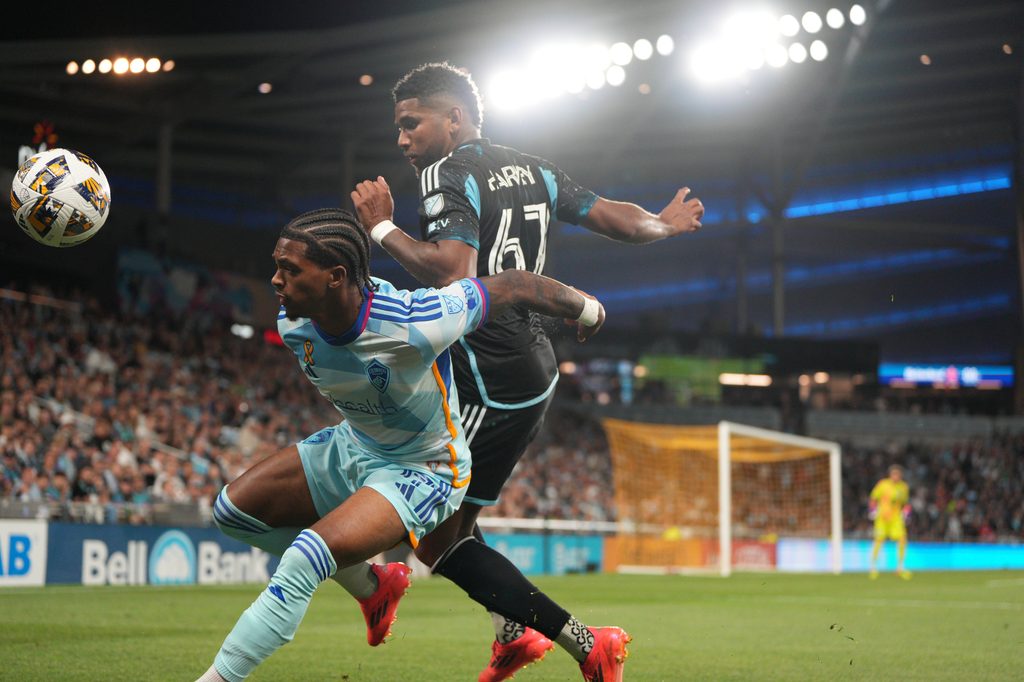 Sep 28, 2024; Saint Paul, Minnesota, USA; Colorado Rapids forward Kimani Stewart-Baynes (27) and Minnesota United midfielder Carlos Harvey (67) fight for possession in the second half at Allianz Field. Mandatory Credit: Matt Blewett-Imagn Images
