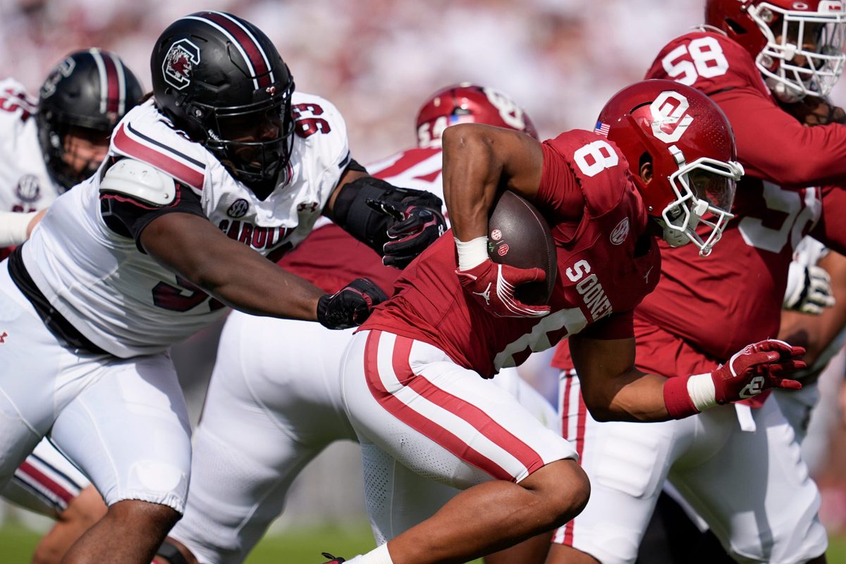 Oklahoma Sooners running back Taylor Tatum (8) runs past South Carolina Gamecocks defensive tackle Nick Barrett (93) during a college football game between the University of Oklahoma Sooners (OU) and the South Carolina Gamecocks at Gaylord Family - Oklahoma Memorial Stadium in Norman, Okla., Saturday, Oct. 19, 2024.