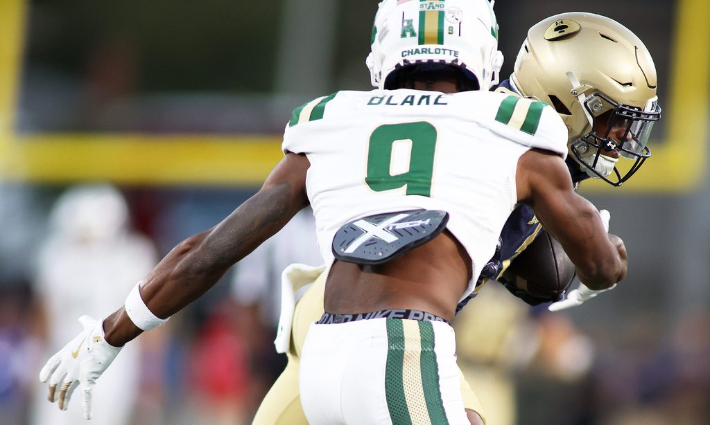 Oct 19, 2024; Annapolis, Maryland, USA; Navy Midshipmen cornerback Dashaun Peele (1) makes an interception over Charlotte 49ers wide receiver O'Mega Blake (9) during the second half at Navy-Marine Corps Memorial Stadium. Mandatory Credit: Daniel Kucin Jr.-Imagn Images