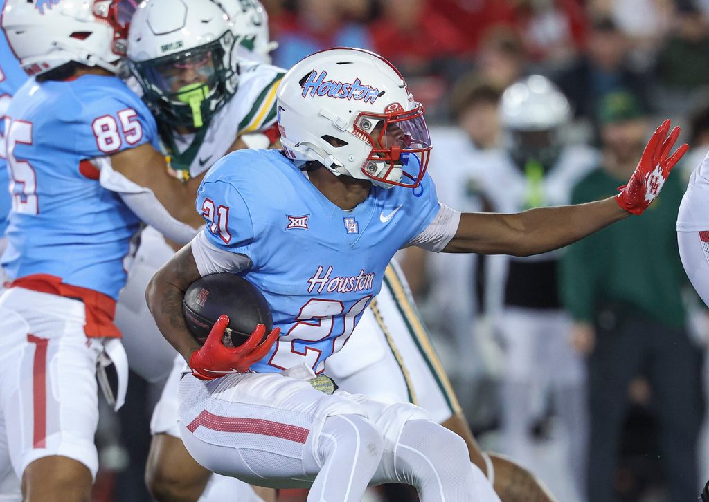 Nov 23, 2024; Houston, Texas, USA; Houston Cougars running back Stacy Sneed (21) runs with the ball during the second quarter against the Baylor Bears at TDECU Stadium. Mandatory Credit: Troy Taormina-Imagn Images