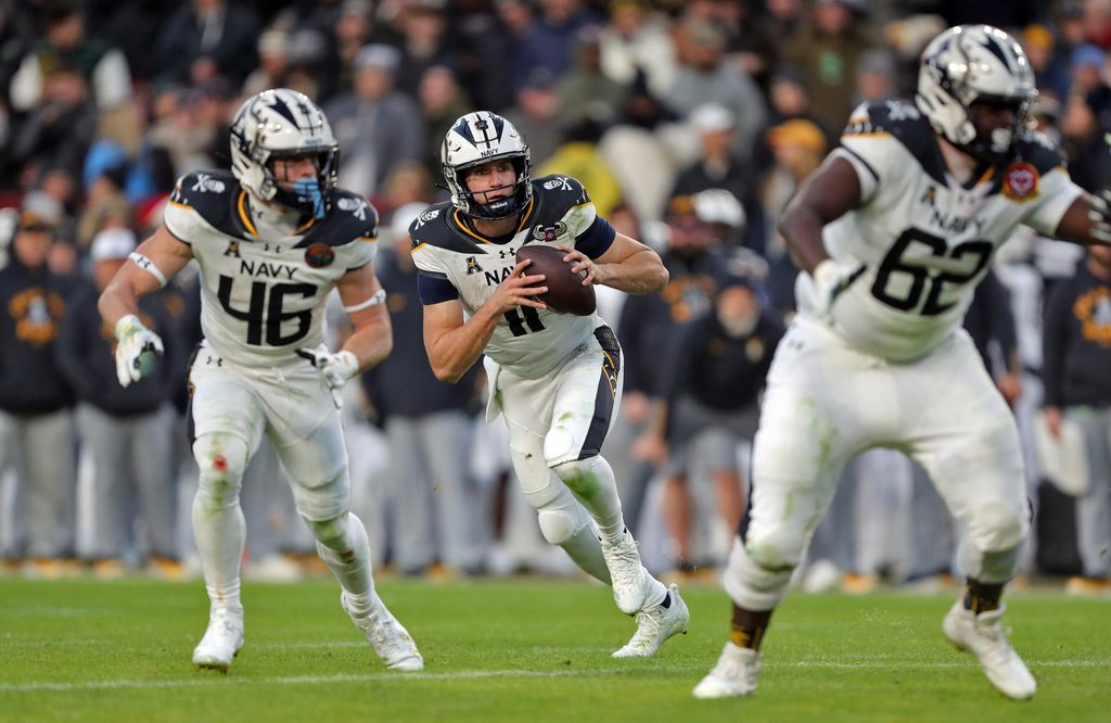 Dec 14, 2024; Landover, Maryland, USA; Navy Midshipmen quarterback Blake Horvath (11) looks to pass against the Army Black Knights during the first half of the the 125th Army-Navy game at Northwest Stadium. Mandatory Credit: Danny Wild-Imagn Images