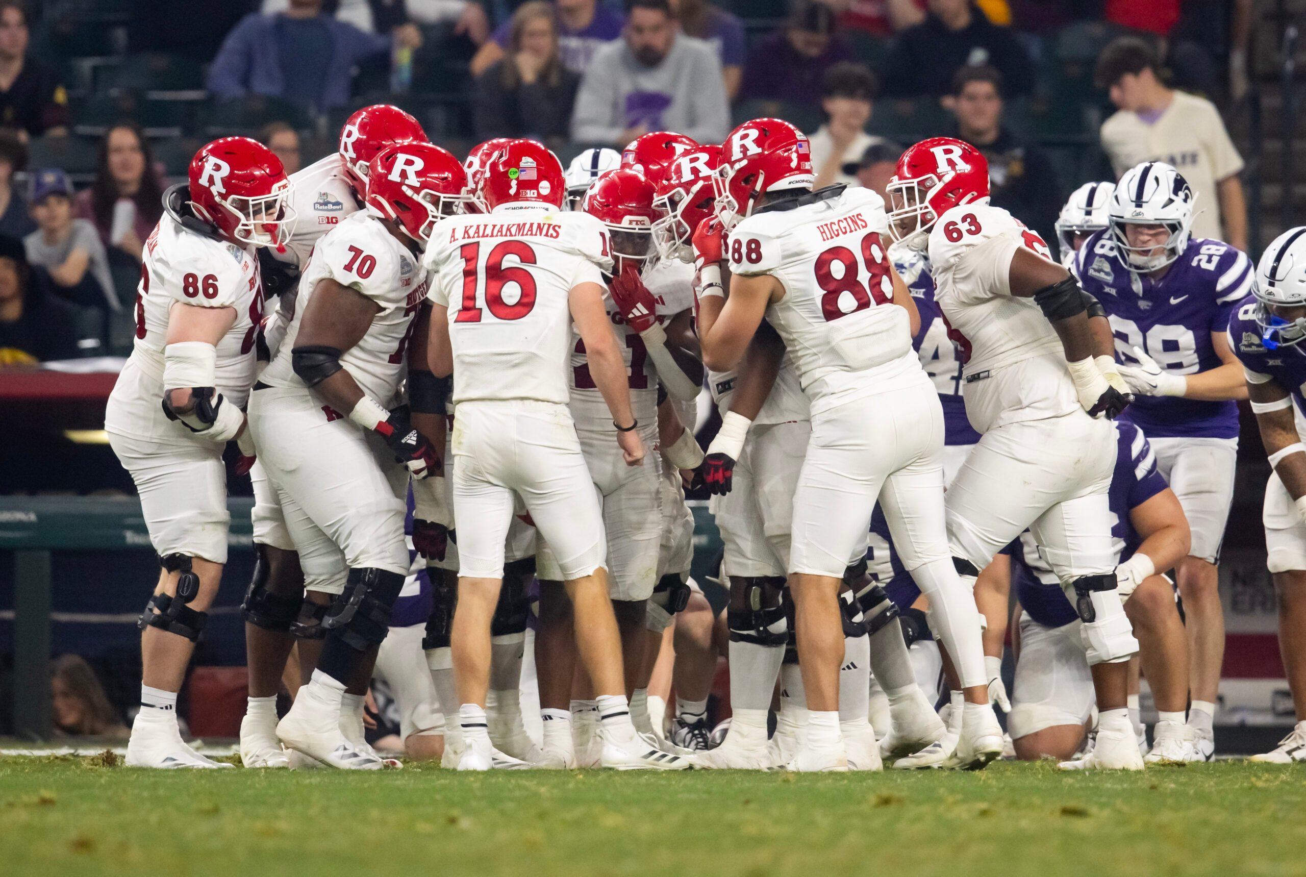 Dec 26, 2024; Phoenix, AZ, USA; Rutgers Scarlet Knights quarterback Athan Kaliakmanis (16) and tight end Mike Higgins (88) in the huddle with teammates against the Kansas State Wildcats during the Rate Bowl at Chase Field. Mandatory Credit: Mark J. Rebilas-Imagn Images