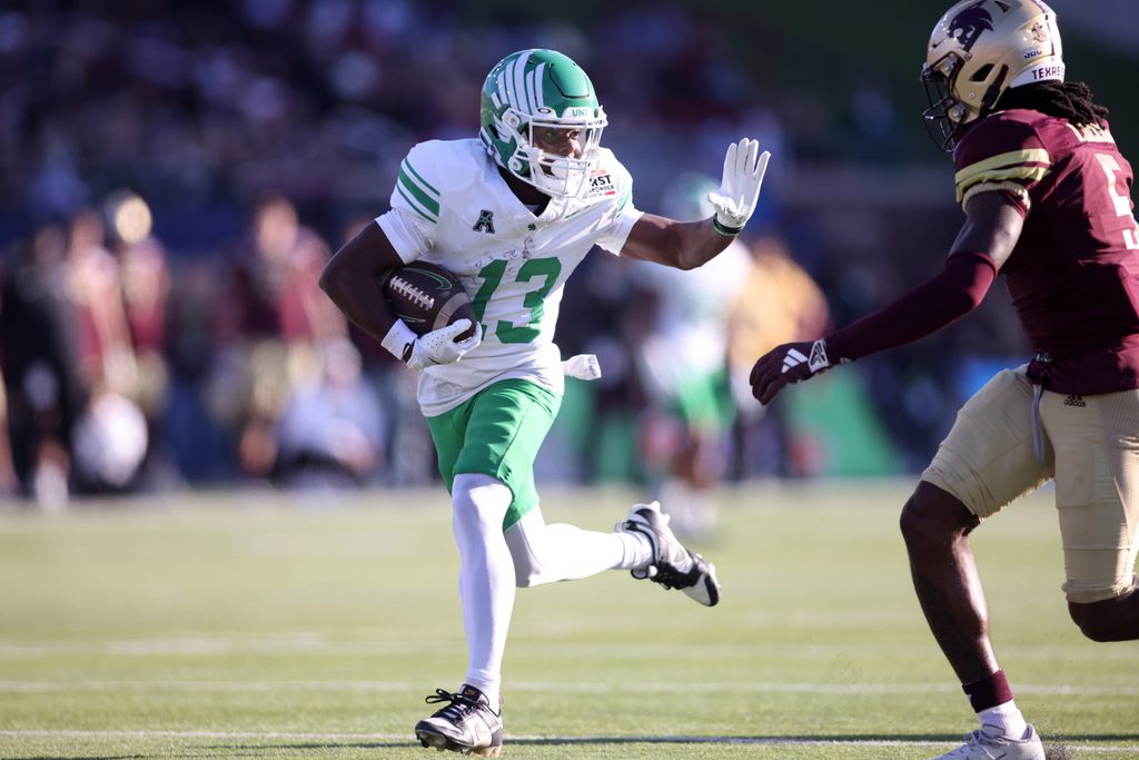 Jan 3, 2025; Dallas, TX, USA; North Texas Mean Green wide receiver Miles Coleman (13) runs for a touchdown against Texas State Bobcats safety Darius Jackson (5) during the first quarter at Gerald J. Ford Stadium. Mandatory Credit: Tim Heitman-Imagn Images