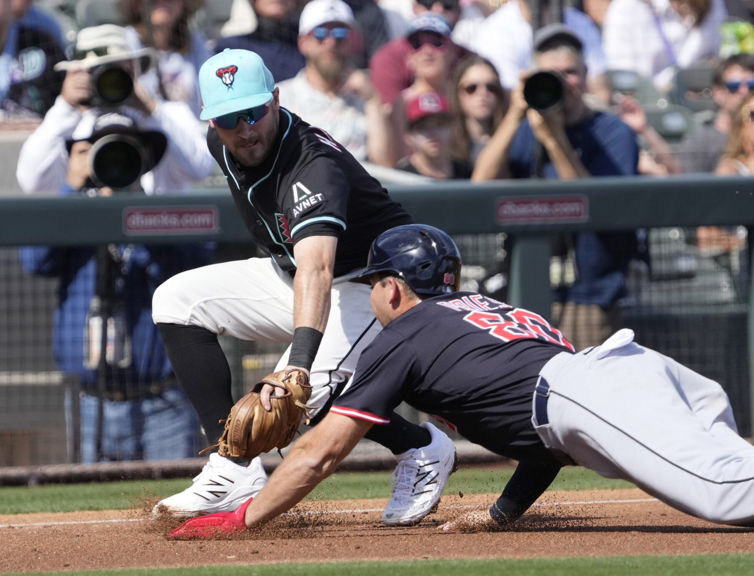 Arizona Diamondbacks third baseman Garrett Hampson tags out Cleveland Guardians Micah Pries during a spring training game at Salt River Fields on Feb. 24, 2025.