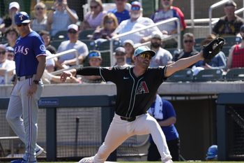 Arizona Diamondbacks first baseman Trey Mancini stretches for a throw against the Texas Rangers during Cactus League play at Salt River Fields on March 9, 2025.