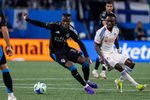 Mar 15, 2025; Charlotte, North Carolina, USA; Charlotte FC forward Wilfried Zaha (10) cuts back against FC Cincinnati midfielder Obinna Nwobodo (5) during the second half at Bank of America Stadium. Mandatory Credit: Scott Kinser-Imagn Images