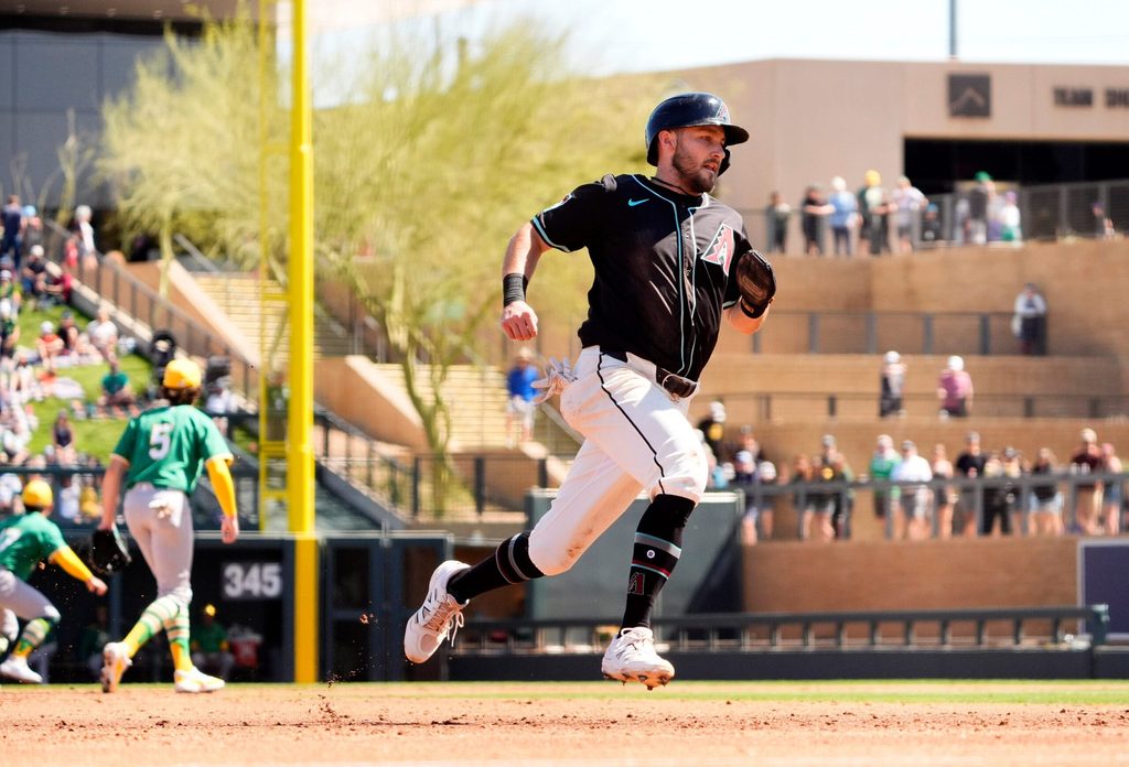 Arizona Diamondbacks Garrett Hampson scores on a Randal Grichuk single off Athletics starting pitcher Joey Estes in the second inning during a spring training game at Salt River Fields in Scottsdale on March 20, 2025.