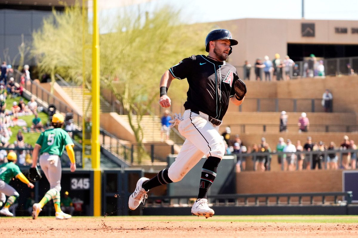 Arizona Diamondbacks Garrett Hampson scores on a Randal Grichuk single off Athletics starting pitcher Joey Estes in the second inning during a spring training game at Salt River Fields in Scottsdale on March 20, 2025.