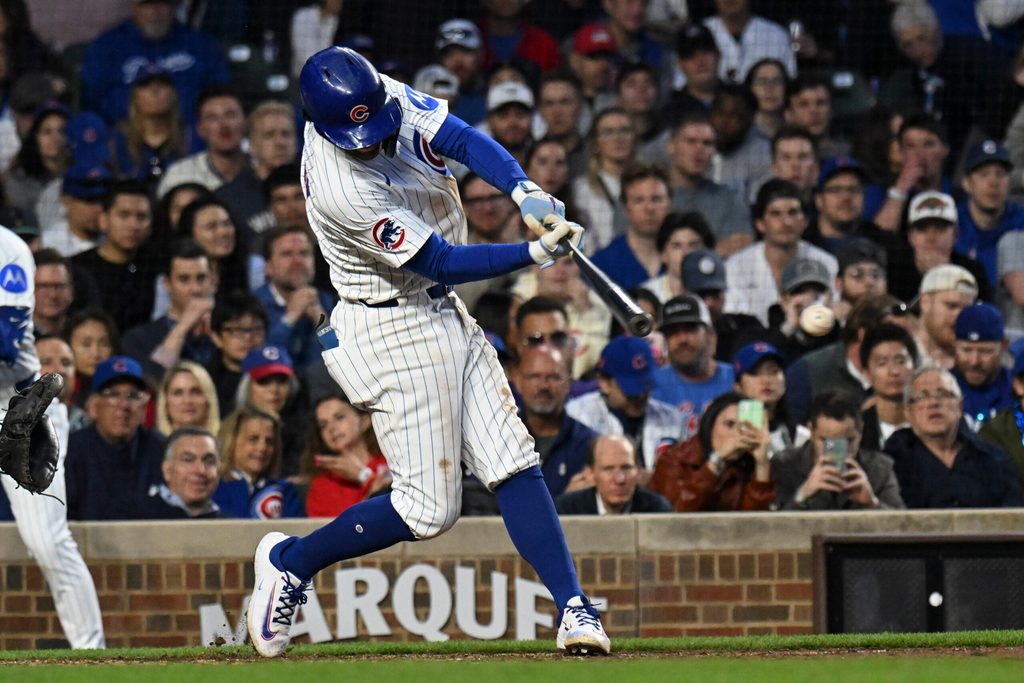 Apr 23, 2025; Chicago, Illinois, USA; Chicago Cubs shortstop Dansby Swanson (7) hits a two RBI single against the Los Angeles Dodgers during the fifth inning at Wrigley Field. Mandatory Credit: Matt Marton-Imagn Images