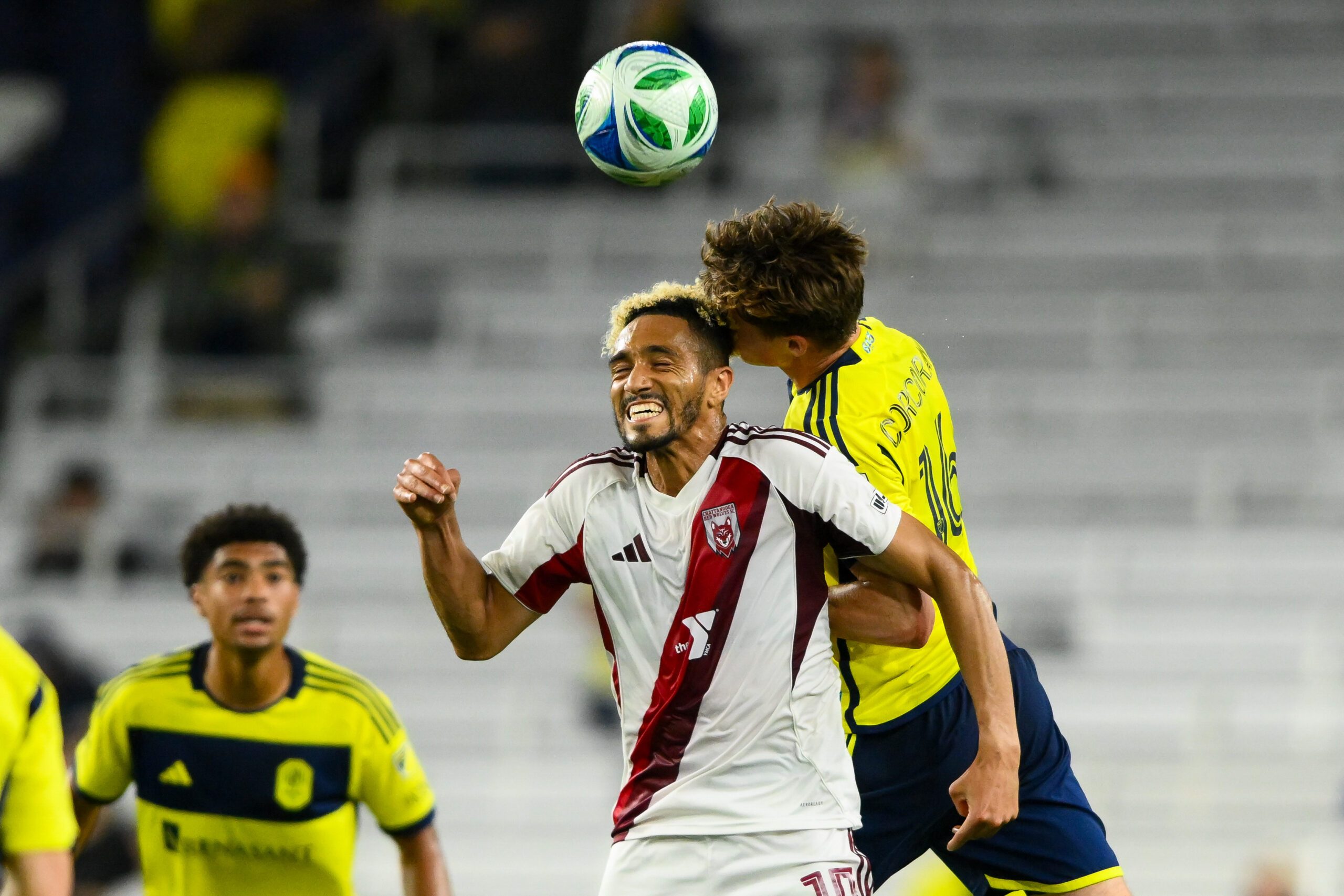 May 6, 2025; Nashville, Tennessee, USA; Nashville SC midfielder Matthew Corcoran (16) and Chattanooga Red Wolves center fielder Matt Bentley (10) fights for the ball during the second half at GEODIS Park. Mandatory Credit: Steve Roberts-Imagn Images