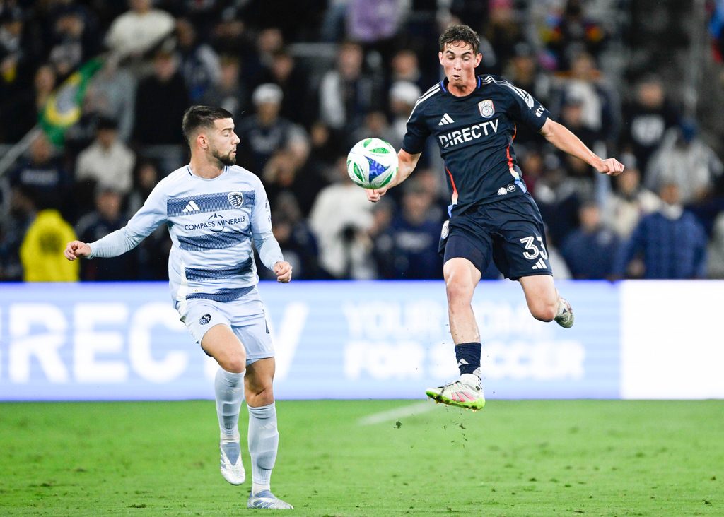 May 17, 2025; San Diego, California, USA; San Diego FC defender Oscar Verhoeven (33) fights for the ball with Sporting Kansas City defender Robert Voloder (4) during the first half at Snapdragon Stadium. Mandatory Credit: Denis Poroy-Imagn Images