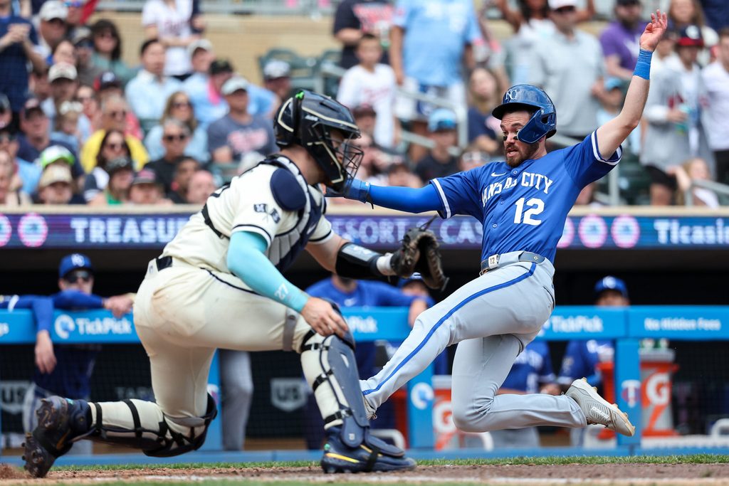 May 25, 2025; Minneapolis, Minnesota, USA; Kansas City Royals left fielder Nick Loftin (12) scores the go ahead run on a double hit third baseman Maikel Garcia (11) during the tenth inning against the Minnesota Twins at Target Field. Mandatory Credit: Matt Krohn-Imagn Images