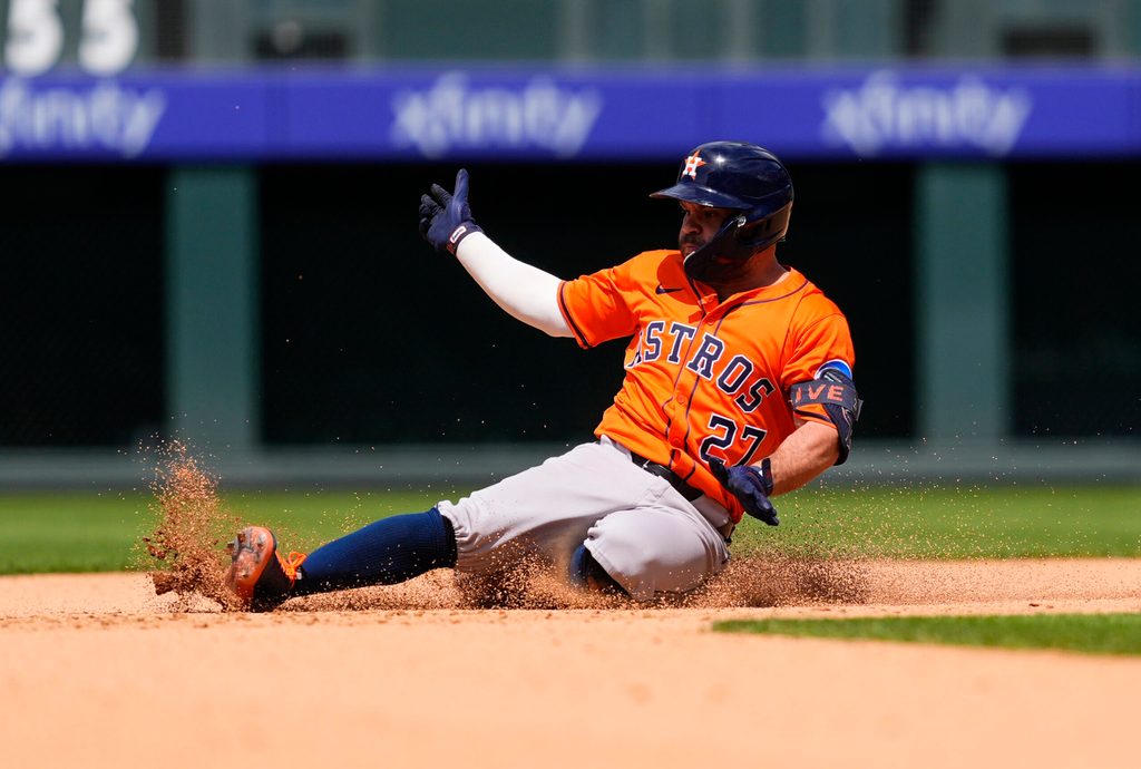 Jul 3, 2025; Denver, Colorado, USA; Houston Astros designated hitter Jose Altuve (27) slides for a double in the seventh inning against the Colorado Rockies at Coors Field. Mandatory Credit: Ron Chenoy-Imagn Images