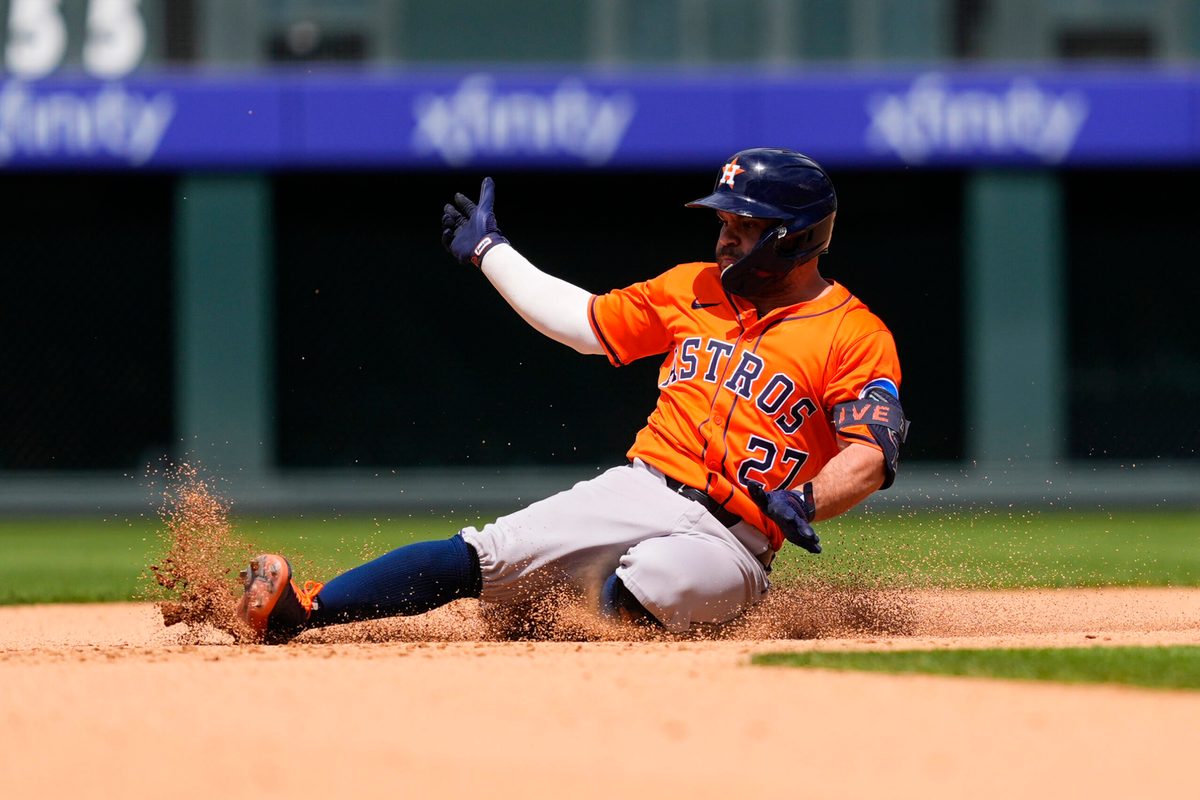 Jul 3, 2025; Denver, Colorado, USA; Houston Astros designated hitter Jose Altuve (27) slides for a double in the seventh inning against the Colorado Rockies at Coors Field. Mandatory Credit: Ron Chenoy-Imagn Images