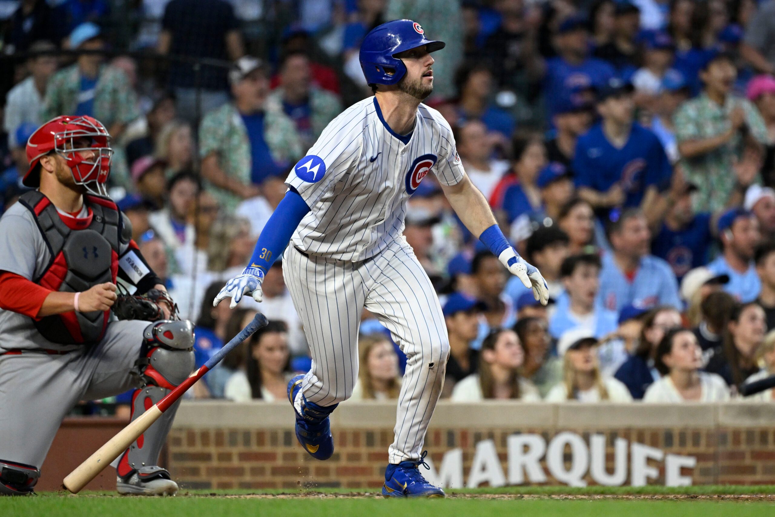 Jul 6, 2025; Chicago, Illinois, USA;  Chicago Cubs outfielder Kyle Tucker (30) hits an RBI sacrifice fly ball during the third inning against the St. Louis Cardinals at Wrigley Field. Mandatory Credit: Matt Marton-Imagn Images