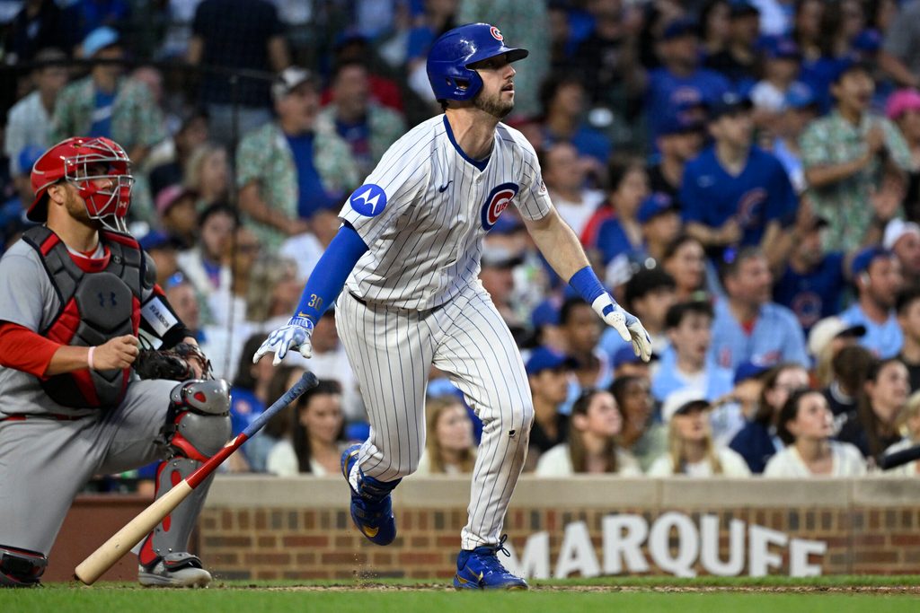Jul 6, 2025; Chicago, Illinois, USA; Chicago Cubs outfielder Kyle Tucker (30) hits an RBI sacrifice fly ball during the third inning against the St. Louis Cardinals at Wrigley Field. Mandatory Credit: Matt Marton-Imagn Images