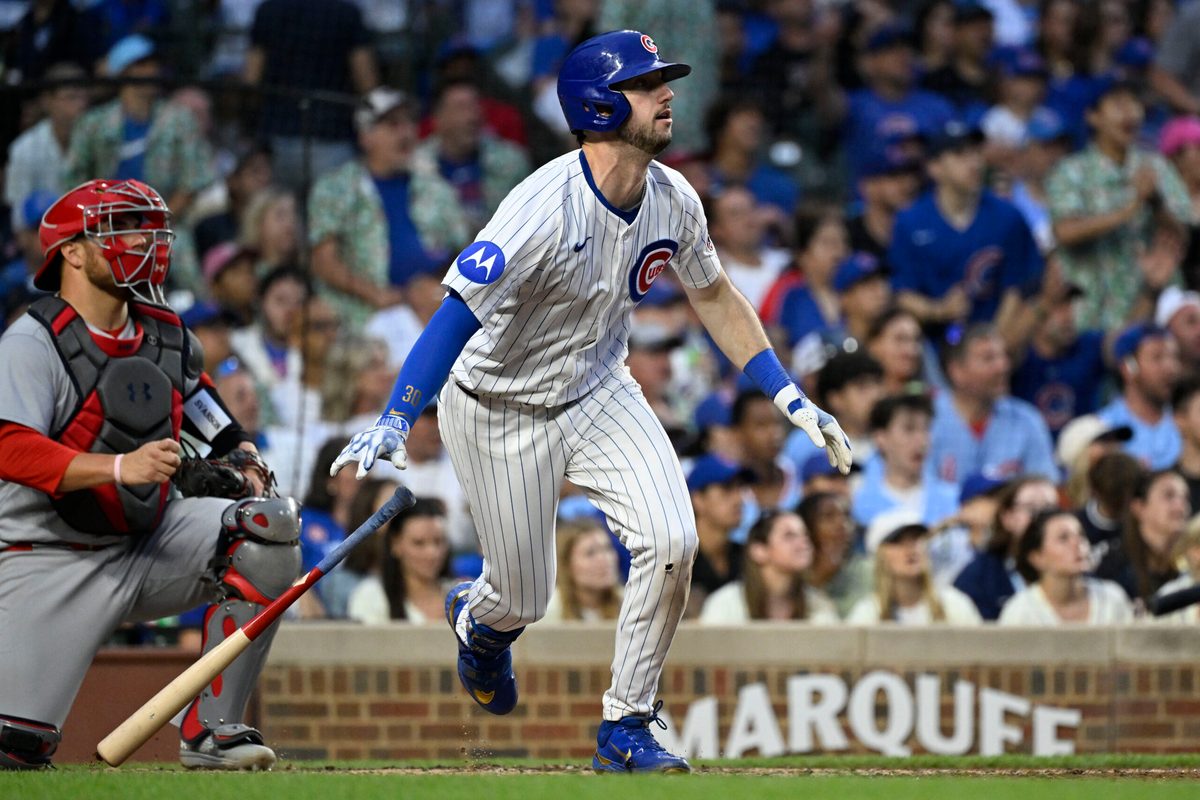 Jul 6, 2025; Chicago, Illinois, USA; Chicago Cubs outfielder Kyle Tucker (30) hits an RBI sacrifice fly ball during the third inning against the St. Louis Cardinals at Wrigley Field. Mandatory Credit: Matt Marton-Imagn Images