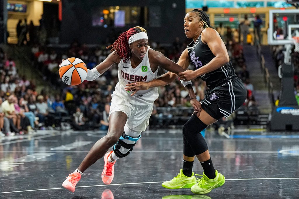 Jul 7, 2025; College Park, Georgia, USA; Atlanta Dream guard Rhyne Howard (10) dribbles against Golden State Valkyries forward Kayla Thornton (5) during the second half at Gateway Center Arena at College Park. Mandatory Credit: Dale Zanine-Imagn Images