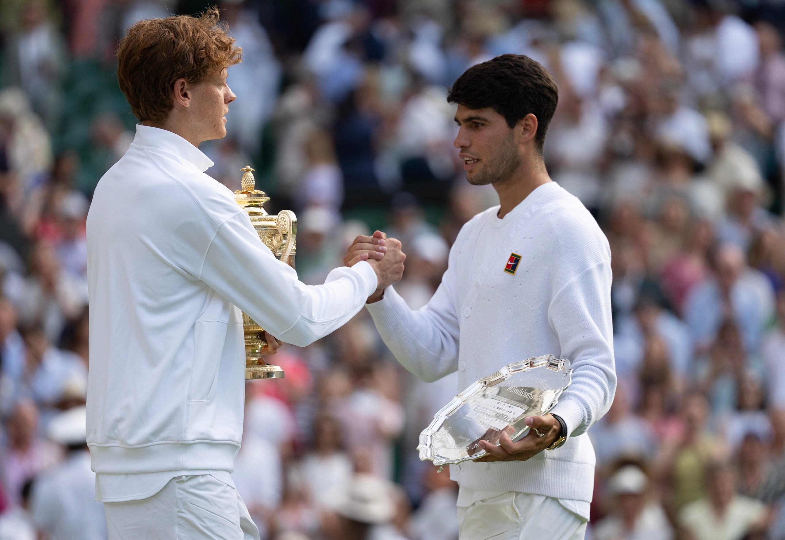 Jul 13, 2025; Wimbledon, United Kingdom; Carlos Alcaraz of Spain and Jannik Sinner of Italy pose with their trophies after the men’s singles final on day 14 at All England Lawn Tennis and Croquet Club. Mandatory Credit: Susan Mullane-Imagn Images