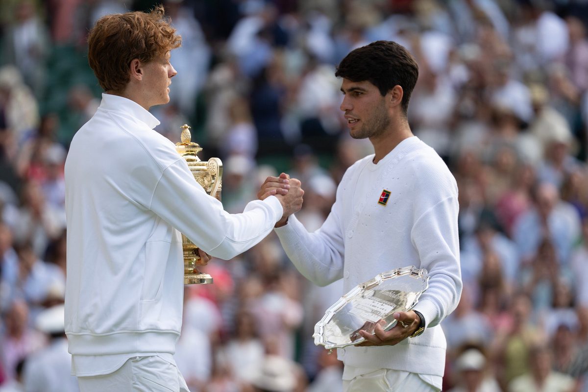 Jul 13, 2025; Wimbledon, United Kingdom; Carlos Alcaraz of Spain and Jannik Sinner of Italy pose with their trophies after the men’s singles final on day 14 at All England Lawn Tennis and Croquet Club. Mandatory Credit: Susan Mullane-Imagn Images